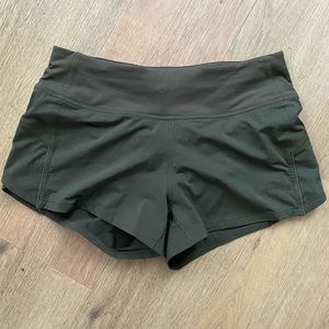 Dark green Lululemon shorts. Size 6. Brand new never worn. Back zipper pocket.